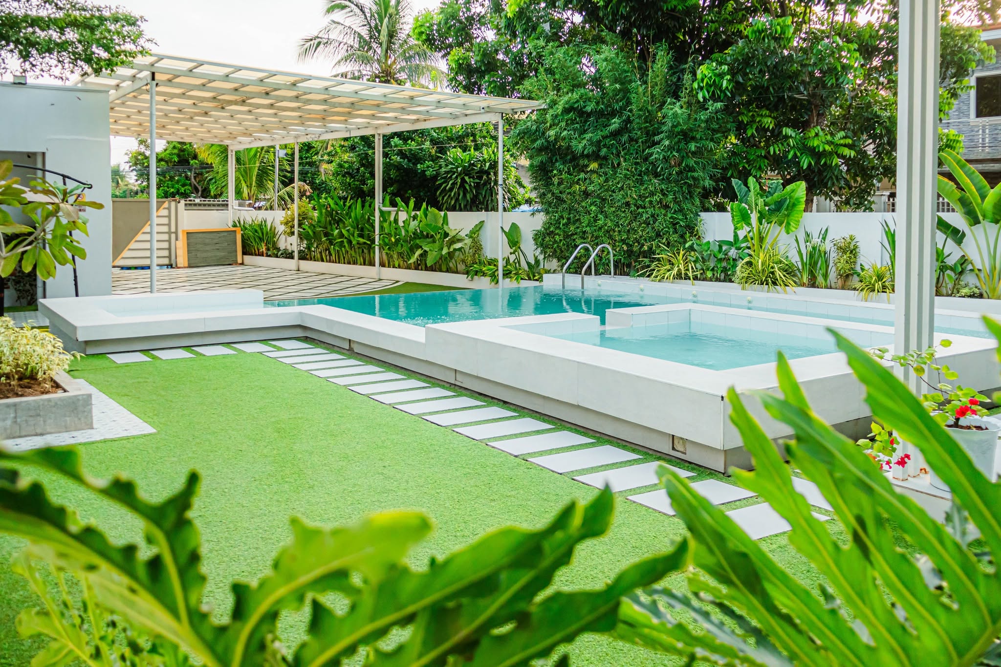 The resort pool, lawn and surrounding greenery